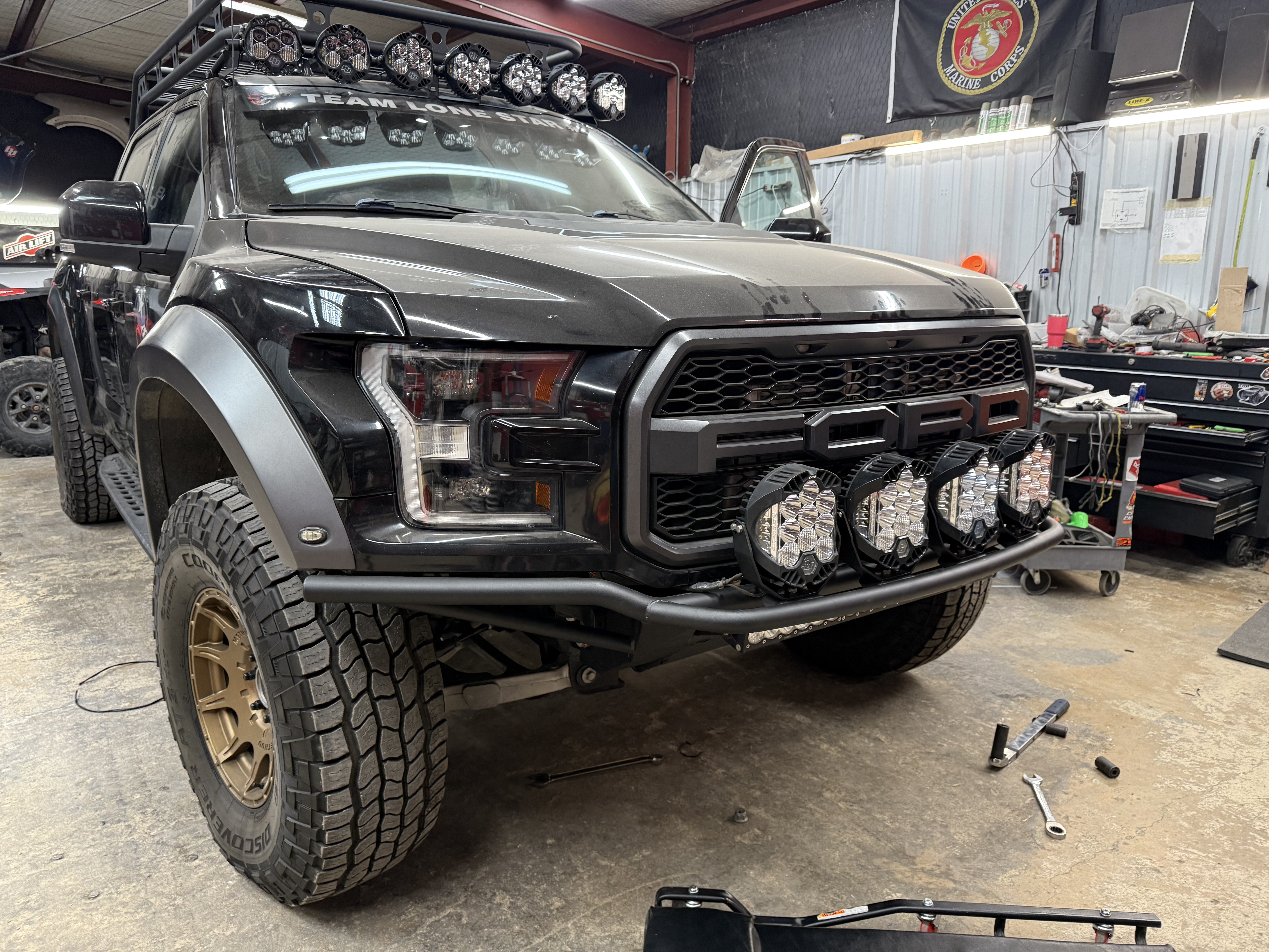 Lifted black Jeep Wrangler with roof rack and winch